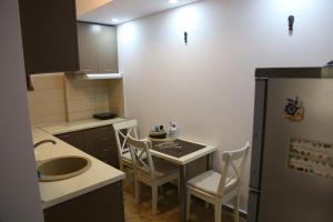 a small kitchen with a table and a refrigerator at AnaMaria Apartments Mamaia Nord in Mamaia Sat/Năvodari +39 photos