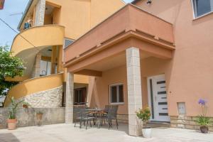a patio of a house with chairs and a table at Apartman Joso 2 in Sukošan +3 photos
