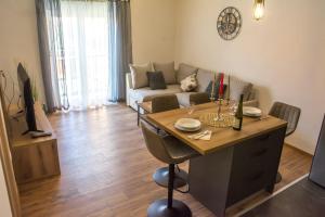a living room with a table and a couch at Apartman Joso 2 in Sukošan
