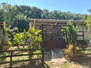 a house with a gate and a fence at Nature's Cottage in Hibberdene