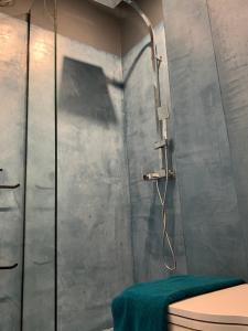 a shower stall in a bathroom with a toilet at Bluetique Apartments Himara in Himare