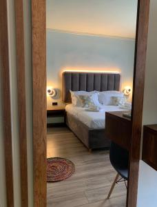 a hotel room with a bed and a desk at Bluetique Apartments Himara in Himare