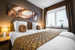 Postel nebo postele na pokoji v ubytování Hotel Maraboe