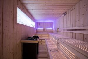 a empty sauna with a purple light in it at Lamondis in Castelrotto