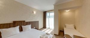 a bedroom with two beds and a large window at Hotel Pautalia in Sunny Beach +43 photos
