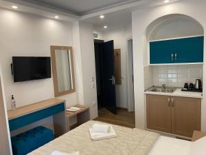 a kitchen with blue cabinets and a sink at Hotel Medusa in Skala Prinou