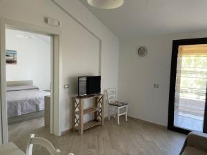 a bedroom with a bed and a tv and a mirror at Delia's house in Drapia