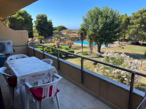 a balcony with a table and chairs and a pool at Delia's house in Drapia