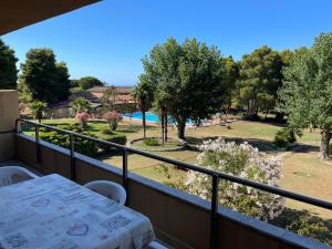a balcony with a table and a view of a yard at Delia's house in Drapia +4 photos