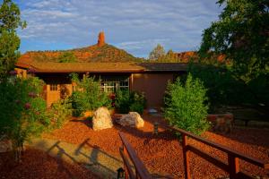 a house with a fence in front of a yard at Sedona Studio at Thunder Mountain in Sedona