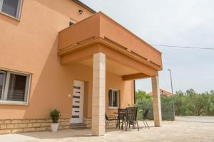 a patio with chairs and a table in a house at Apartman Joso 3 in Sukošan