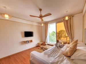 a living room with a couch and a ceiling fan at Jeym Lodge in Thoddoo