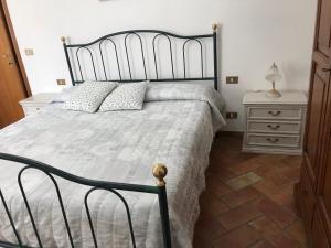 a bedroom with a large bed and a night stand at Agriturismo San Leone in Volterra +71 photos