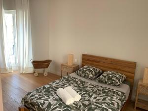 a bedroom with a bed with two pillows at La maison cocooning in Narbonne