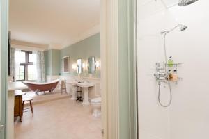 a bathroom with a bath tub and a claw foot bath tub at Burton Court in Dilwyn +54 photos
