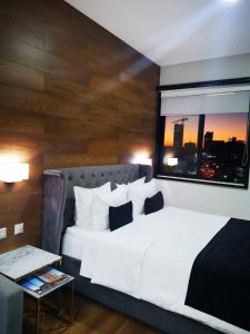 a bedroom with a large white bed and a window at TRYP by Wyndham Santa Cruz in Santa Cruz de la Sierra