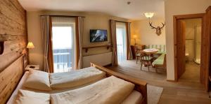 a living room with a couch and a dining room at Hotel Neuwirt in Brandenberg