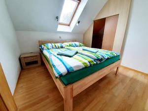 a bedroom with a bed with a wooden floor at Apartmány Srní u Hlinska in Hlinsko