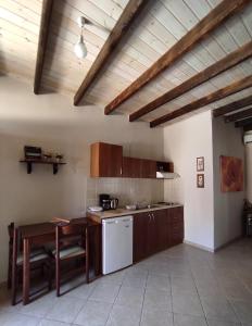 a kitchen with a table and a counter top at Epavli Veneti in Parga +47 photos