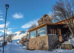 a house with a tower on top of it in the snow at Lodge en Farellones in Santiago