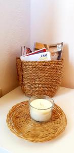 a basket and a bowl on a table with a candle at Room Cvita in Trogir