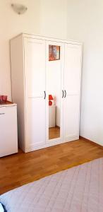 a white cabinet in the corner of a room at Room Cvita in Trogir