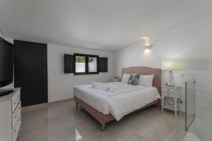 ein Schlafzimmer mit einem großen Bett und einem TV in der Unterkunft Casa da Praca - City Center - Faro in Faro