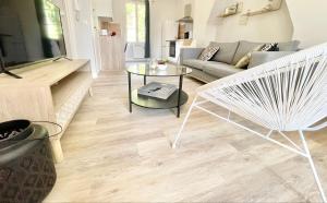 a living room with a couch and a table at Arina & Julien Dieppe in Dieppe