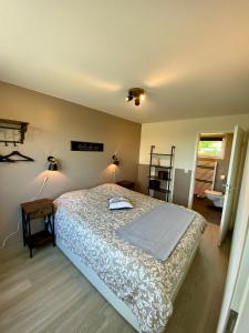 a bedroom with a bed and a table and two lamps at La Grange du Logis in Waimes +64 photos