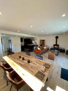 a large living room with a large wooden table at La Grange du Logis in Waimes