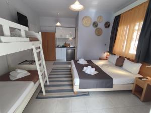 a bedroom with two bunk beds and a kitchen at Villa Riviera in Stavros