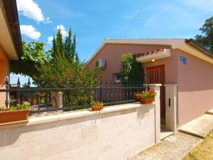 a house with potted plants on a fence at House Vodnjan 2106 in Vodnjan
