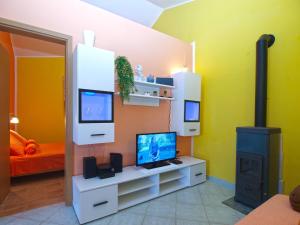 a living room with a tv and a stove at House Vodnjan 2106 in Vodnjan