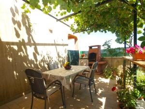 a patio with a table and chairs under a pergola at House Vodnjan 2106 in Vodnjan