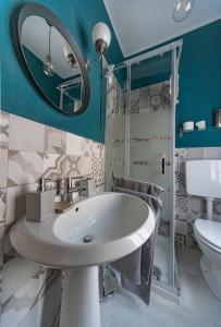 a bathroom with a sink and a mirror at Sophia's Loft in Parma