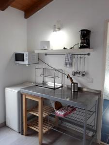a kitchen with a table and a refrigerator at Milfontes Private Homes II - Duna Parque Group in Vila Nova de Milfontes