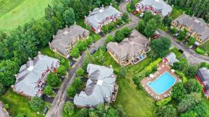 an aerial view of a house with a pool at Townhouse With Free Shuttle To Tremblant Resort in Mont-Tremblant