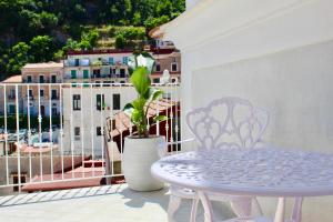 a table and chairs on a balcony with a view at Cetara Costa d'Amalfi Residence in Cetara