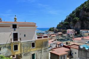 a view of a city with a mountain in the background at Cetara Costa d'Amalfi Residence in Cetara