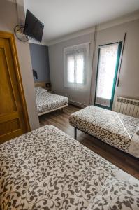 Posteľ alebo postele v izbe v ubytovaní Hostal La Pastora