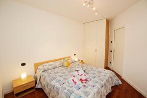 a bedroom with a bed with stuffed animals on it at Appartamento Aurora in Riva del Garda