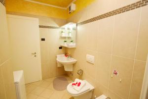 a bathroom with a toilet and a sink at Appartamento Aurora in Riva del Garda