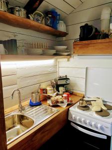 a small kitchen with a sink and a stove at Archontiko Iosif in Tsagarada