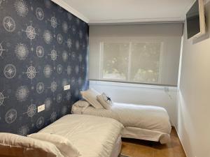 Łóżko lub łóżka w pokoju w obiekcie Portosín -Suites