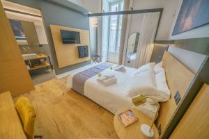 Postel nebo postele na pokoji v ubytování Cafuné Rooms