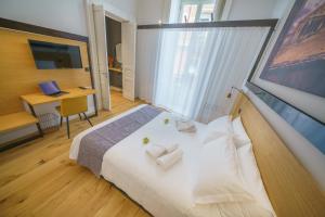 Postel nebo postele na pokoji v ubytování Cafuné Rooms