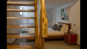 a bedroom with a bunk bed and a staircase at Hostal Extramuros in Conil de la Frontera
