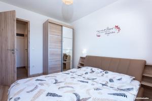 a bedroom with a bed with a comforter on it at Apartament Carpe Diem Brasov in Braşov