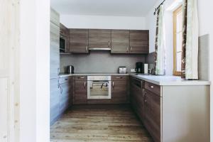 a kitchen with wooden cabinets and a stove top oven at Andis Almdorf in Sölden