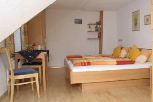 a bedroom with a bed and a desk and a chair at Haus Sonnbühel in Brand